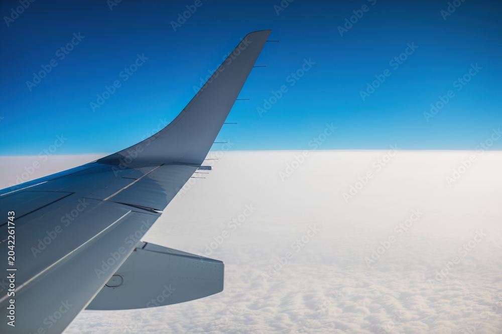 Fototapeta premium Aerial view from the plane over fluffy clouds