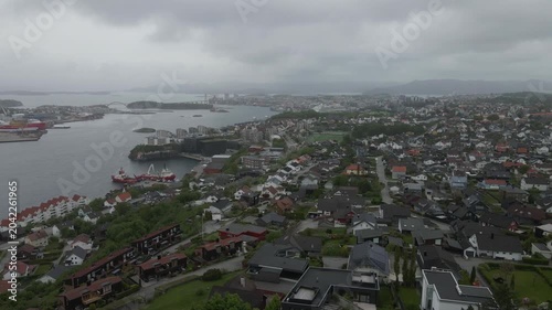 This high-quality aerial drone footage captures a quiet residential neighborhood on the outskirts of Stavanger, Norway. Filmed during the midday hours under a soft, overcast sky.