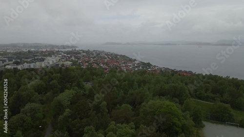 This high-quality aerial drone footage captures a quiet residential neighborhood on the outskirts of Stavanger, Norway. Filmed during the midday hours under a soft, overcast sky.