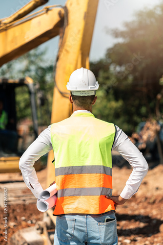 Construction Worker Operating Excavator Machinery During Infrastructure Development And Industrial Engineering Project