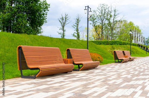 Modern wooden park benches. Landscape design.