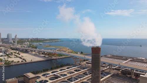 flying counter clockwise around smokestack revealing downtown Milwaukee