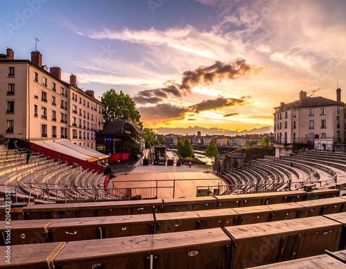 Historic European city square at golden hour with carousel.