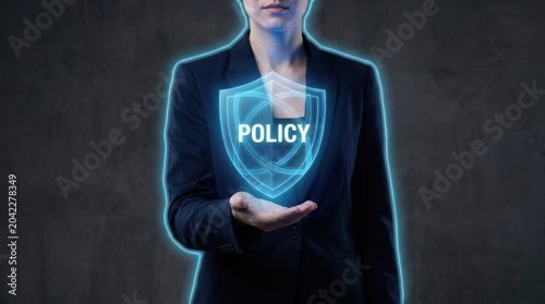 Businesswoman holding glowing shield with policy text, representing business protection.
