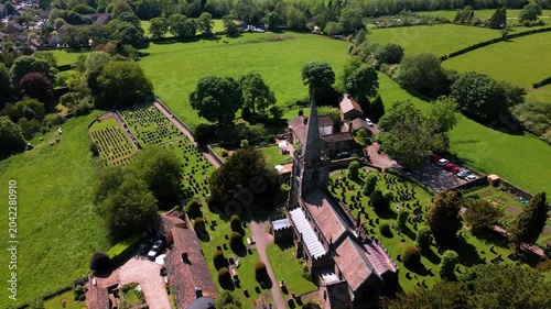 Aerial drone parallax shot of St Michael and All Angels Church spire with Hathersage village view