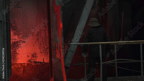 Bild auf Leinwand Worker Near Fiery Furnace Glow