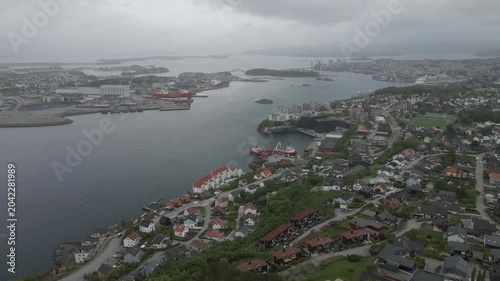 This high-quality aerial drone footage captures a quiet residential neighborhood on the outskirts of Stavanger, Norway. Filmed during the midday hours under a soft, overcast sky.