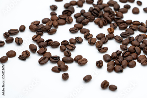 Konstfotografi Scattered Roasted Coffee Beans on White Background with Copy Space