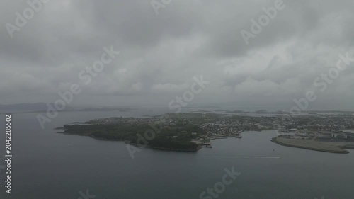 This high-quality aerial drone footage captures a quiet residential neighborhood on the outskirts of Stavanger, Norway. Filmed during the midday hours under a soft, overcast sky.