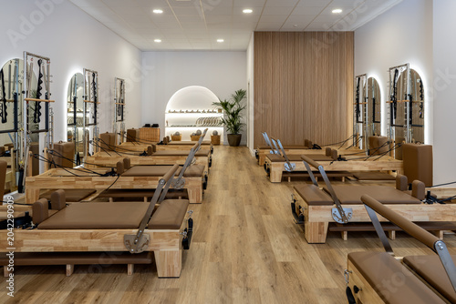 Φωτογραφία Pilates reformer studio with warm wooden interior