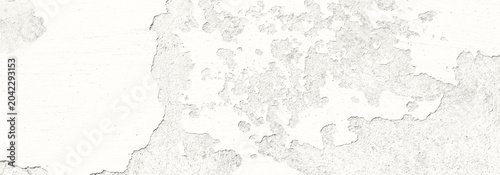 Close-up of peeling white paint texture on an aged concrete wall with weather...