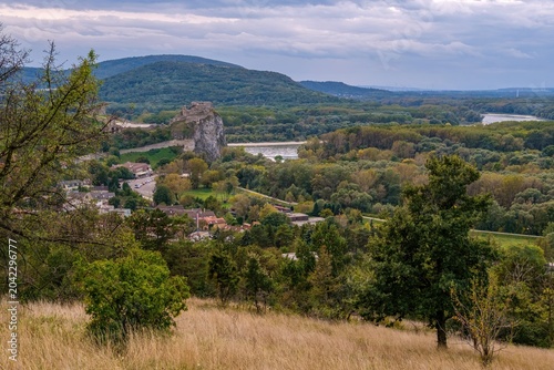 Schilderij op canvas Beautiful scenic view of Devin Castle ruin on a cliff above the confluence of Danube and Morava rivers, surrounded by lush green nature and hills near Bratislava city in Slovakia, Europe