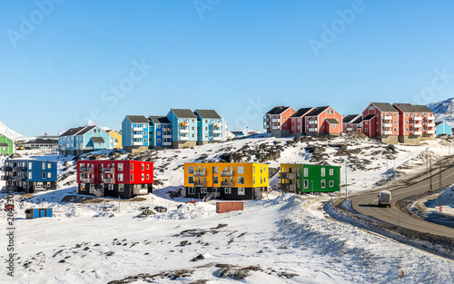 Obraz na płótnie Modern colorful apartment blocks and Inuit residential houses on a frozen hillsi