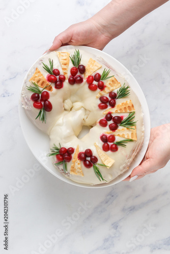 Pie with marzipan, cranberries and rosemary. A pretzel. Selective focus
