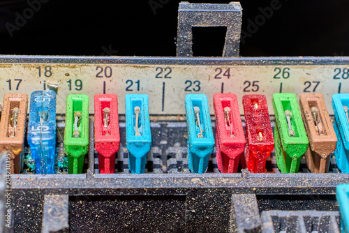 Tableau sur toile Close-up view of colorful car fuse box with various amperages