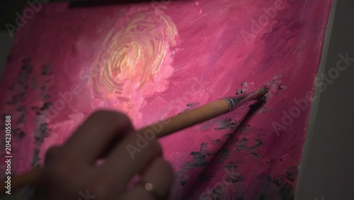 Fotografía Intimate Studio Scene Capturing Fingertip Guiding Brush To Add Gold Accents On Textured Pink Sky Painting
