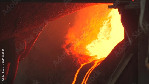 Bild auf Leinwand Closeup Of Industrial Casting Process With Bright Molten Steel Cascading And Sparks Flying Rapidly
