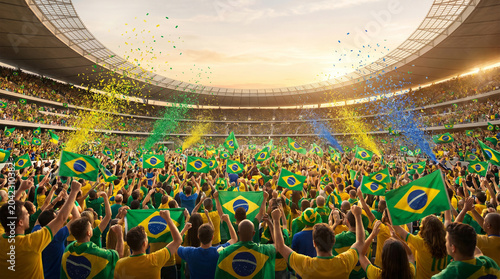 Brazilian football fans celebrating with flags and confetti in a stadium
