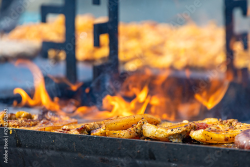 Tableau sur toile A captivating, close-up commercial shot of seasoned pork belly steaks sizzling on a hot flat-top grill surface