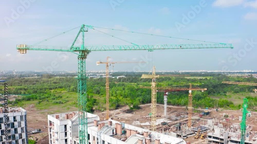 Construction site activity with tower cranes at residential development in an urban setting