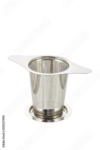 A stainless steel tea filter with perforations, isolated on a white background. This kitchen tool is ideal for steeping tea leaves.