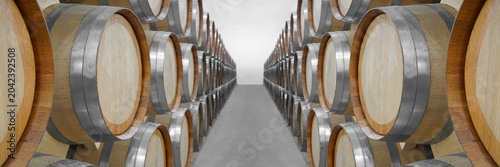 Schilderij op canvas Wine or cognac barrels in the cellar of the winery, Wooden wine barrels in perspective