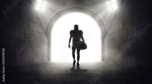 football player walking through tunnel silhouette athlete sport walk backlit dramatic lighting sportswear helmet ball