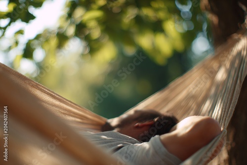 Man sleeping in hammock in garden. Relaxation and summer vacation concept