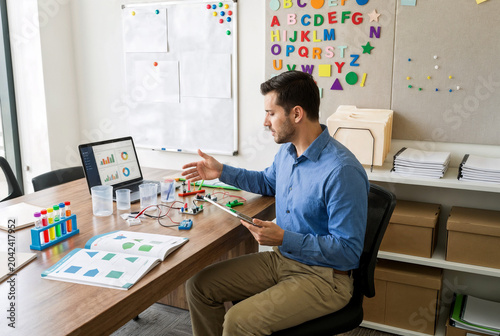 Teacher Preparing Lessons Using Digital Resources In Modern Workspace