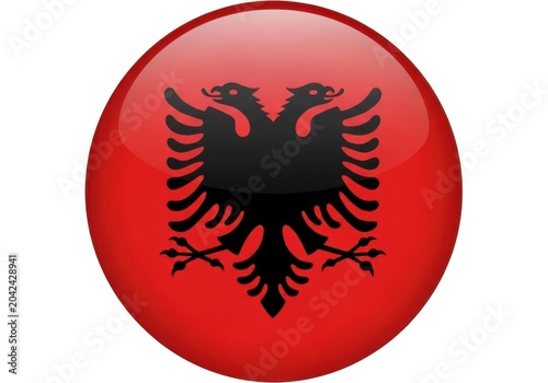 Shiny circular button with the national flag of albania featuring a black double headed eagle on red color isolated on white background
