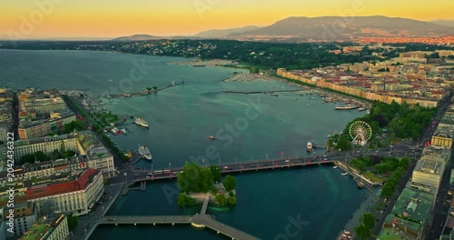 Establishing shot of Geneva city. Aerial view of the Swiss lake town. Rooftops of houses and the lake bay