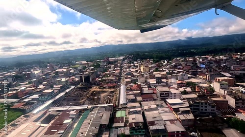 Aerial View of Ecuadorian Town from Small Airplane Wing, Urban Streets, Buildings, Airport Approach and Scenic Aviation Travel Perspective