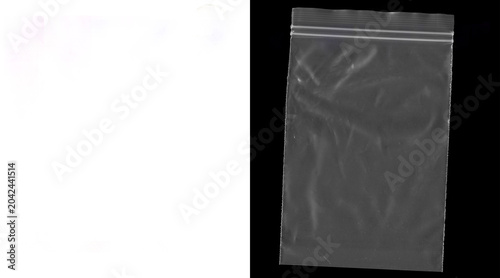 Transparent plastic zipper bag on black background, empty polyethylene zip lock pouch with texture, clear synthetic storage bag for packaging