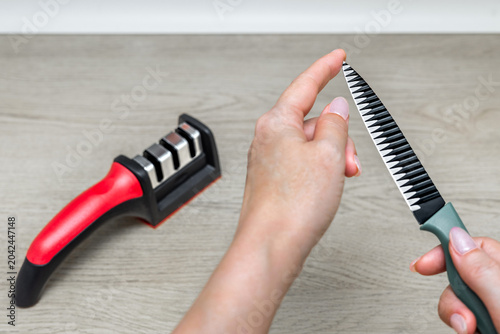 фотографія A finger touches the tip of a knife