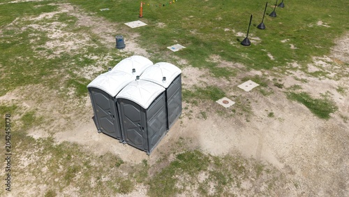 Foto Portable toilets - porta potty on grassy field
