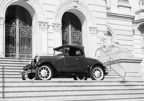 Classic Vintage Car from 1930, Cabriolet. Parked in Front of Historic Building in Black and White