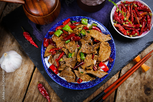 Bild auf Leinwand Spicy stir fried pork liver with chilies and peppers