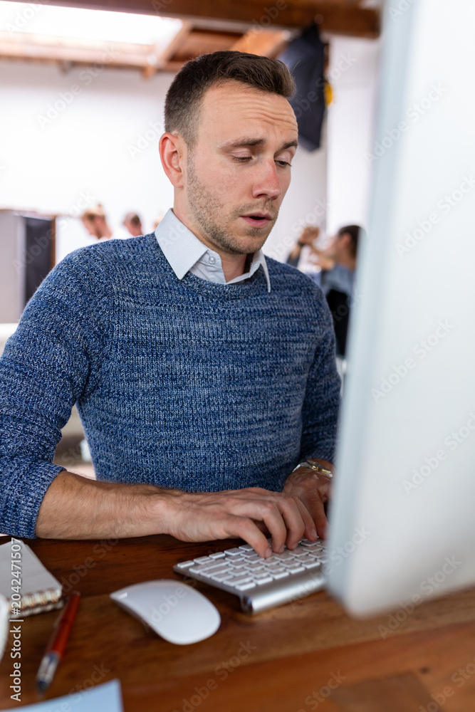 Fototapeta premium Focused man typing office work.