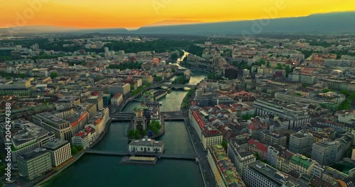 Establishing shot of Geneva city. Aerial view of the Swiss lake town. Rooftops of houses and the lake bay