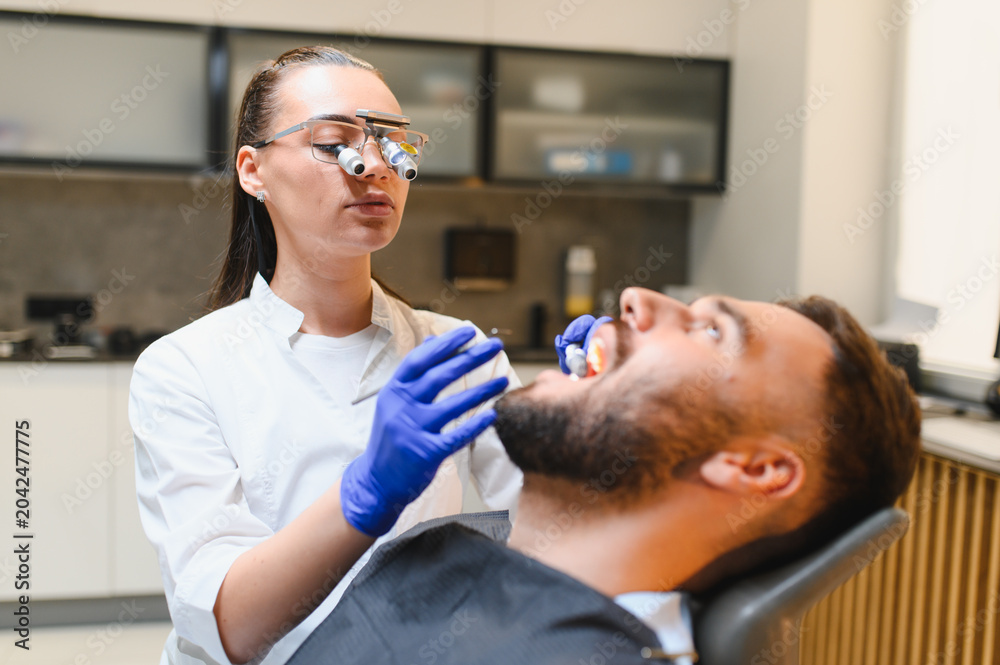 Fototapeta premium Dentist examining patient's oral health in clinic