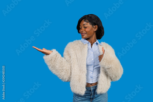 Slika na platnu Young black woman presenting product space with thumbs up