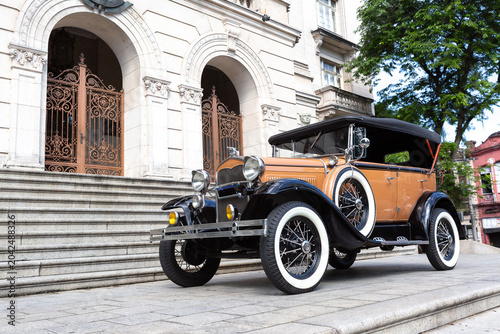 Classic Vintage Car from 1930, Cabriolet. Parked in Front of Historic Building in Black and White