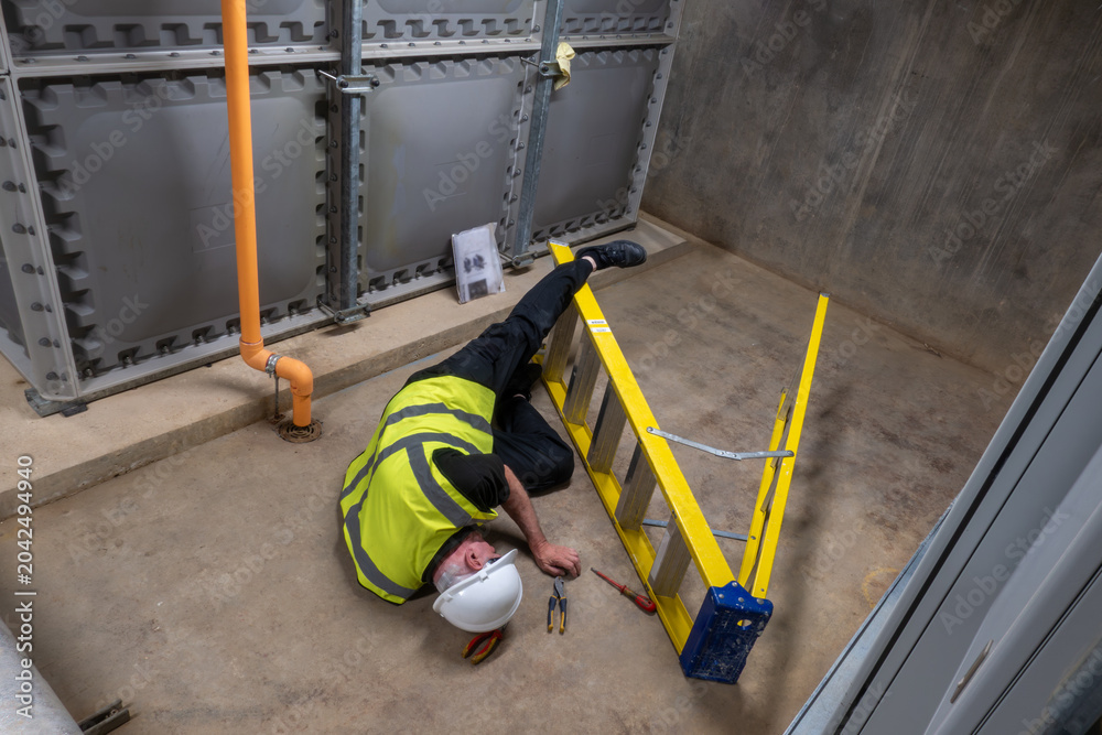 Ταπετσαρία Mature maintenance engineer wearing a hard hat has fallen off his ladder and is lying on the floor injured