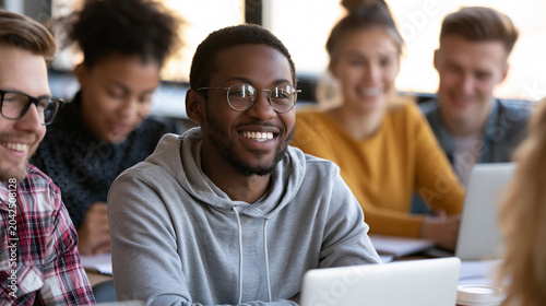Diverse students studying together in classroom
