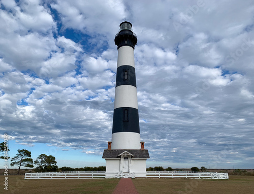Obraz na płótnie Bodie Island Lighthouse rises beneath a dramatic sky of textured clouds in the Outer Banks of North Carolina, a landmark of the Atlantic coast