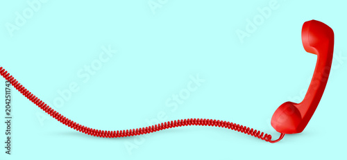 Canvastavla Red telephone handset with long cord on light blue background, banner design