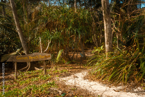Tropical forest trail sign for Anse Caiman at Anse Cocos Beach, La Digue, Seychelles