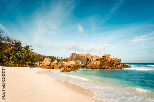 White sand shoreline leading to granite boulders at Anse Cocos, La Digue, Seychelles