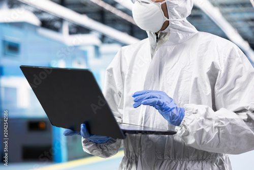 Bild auf Leinwand Designing silicon wafers, laptop close up and scientist man in automated manufacturing plant, Doing quality control, notebook and worker inspecting semiconductor substrates hardware