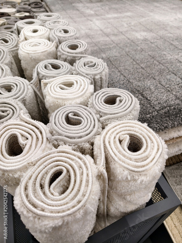 Modern home fluffy carpets in light and gray tones displayed in a megastore creating soft and cozy interior atmosphere